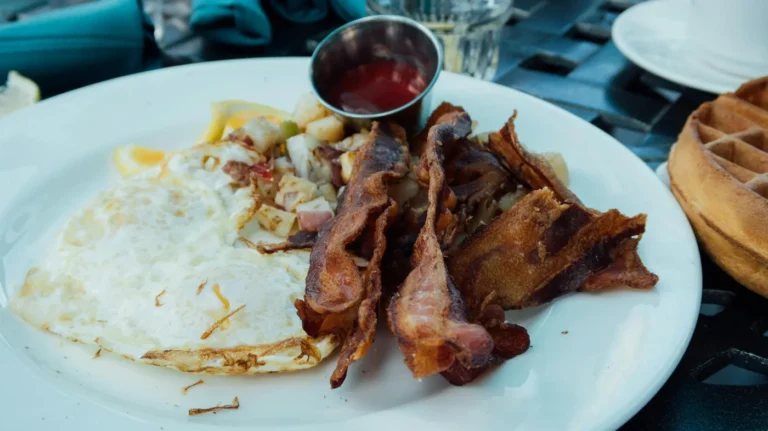 Best fast food breakfast menus in America - A collage of fast food breakfast items: Egg McMuffin, breakfast burrito, chicken biscuit, and ha