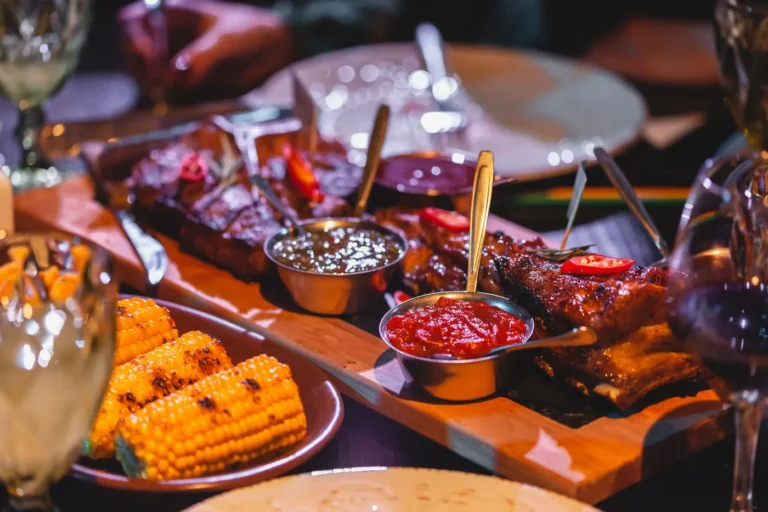 A delicious Memorial Day BBQ platter featuring smoked beef brisket, glazed ribs, pulled pork, and classic Southern sides from a restaurant.