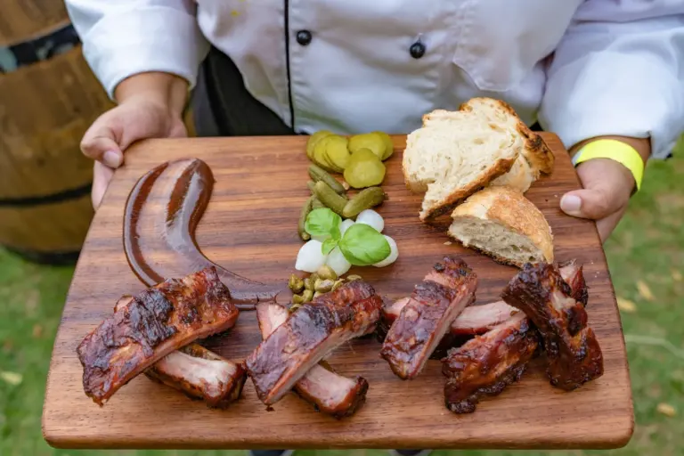 Best BBQ restaurant menu items in America - Assortment of BBQ meats including brisket, ribs, and pulled pork with sides