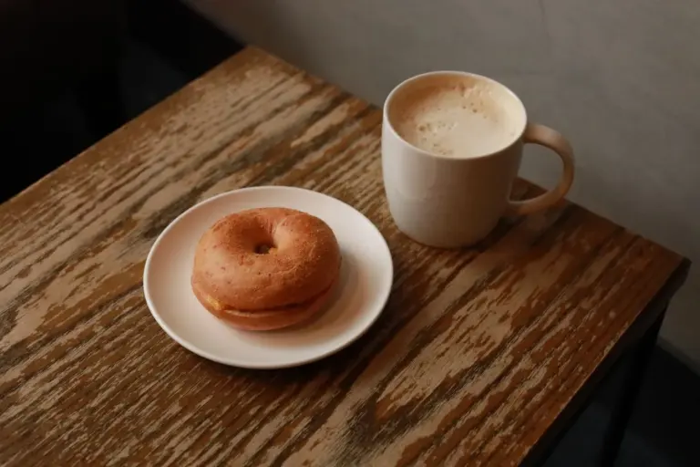 Best coffee chain breakfast items in America - Collage of popular coffee chain breakfast items: Egg McMuffin, Starbucks Impossible Sandwich,