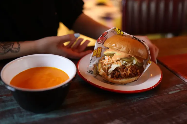 Best comfort food chain restaurants in America - A collage of comfort food dishes from popular chain restaurants, including a waffle, a burg