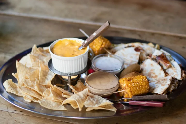 Best Mexican restaurant menu items in America - A platter of assorted Mexican dishes including tacos, burritos, and guacamole