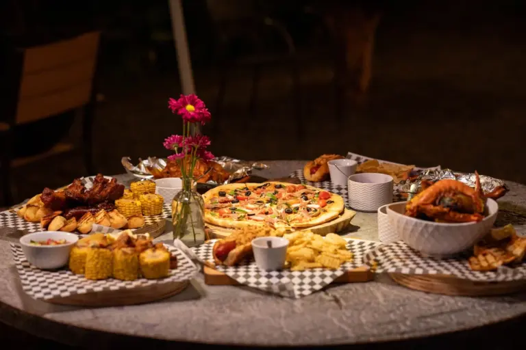 Best restaurant appetizers to share in America - Variety of shareable appetizers including nachos, wings, and sliders on a restaurant table