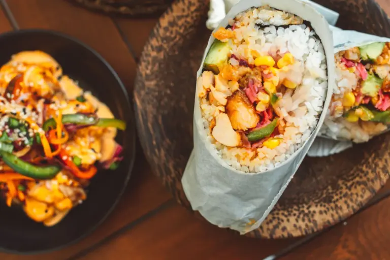 Best restaurant meals before a road trip in America - A healthy burrito bowl with chicken, rice, beans, and vegetables, perfect for eating i