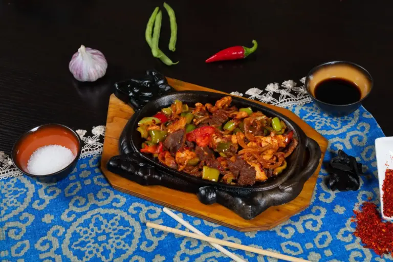 Best spicy restaurant menu items in America - Spicy fried chicken wings and tacos with jalapeños on a wooden table