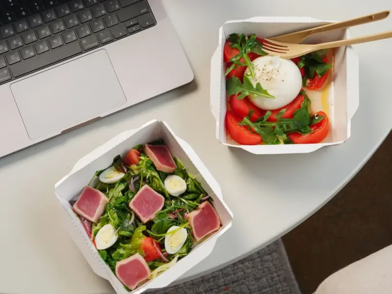 Best restaurant menu items for lunch breaks in America - A quick and healthy lunch break meal with a sandwich and salad on a desk