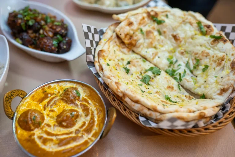 What to Order at an Indian Restaurant: Curry, Bread, Rice, and Spice Guide - Indian dishes spread on table including butter chicken, naan br