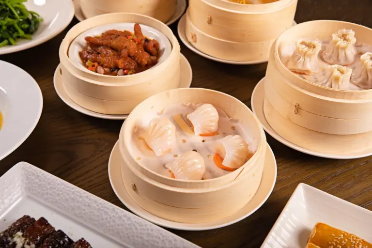 Chinese Restaurant Menu Guide for Weekend Brunch in America - Assorted dim sum dishes on a bamboo steamer at a Chinese brunch table